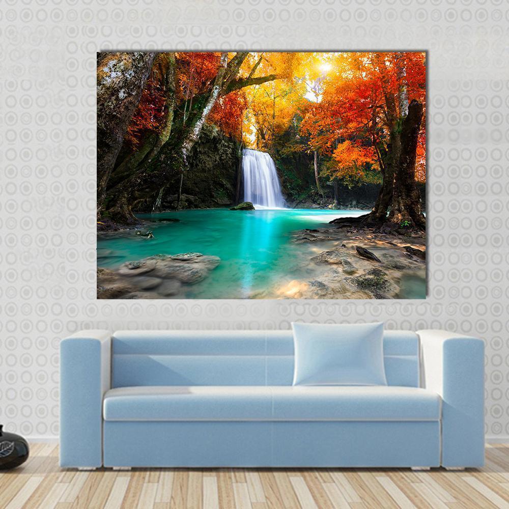 Deep Forest Waterfall Canvas Wall Art in orange, yellow and green, single panel hung on a wall