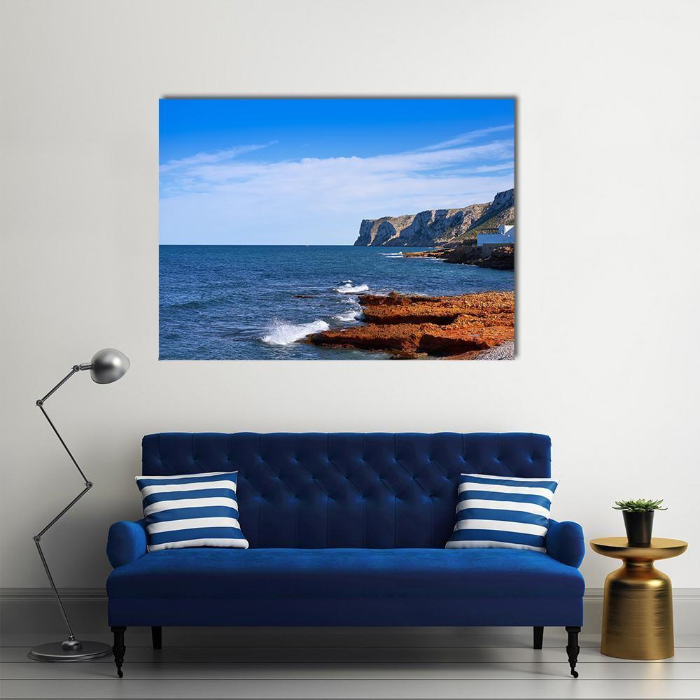 Cliffside Beach with White House Canvas Wall Art in white, brown and blue, single panel hung on a wall