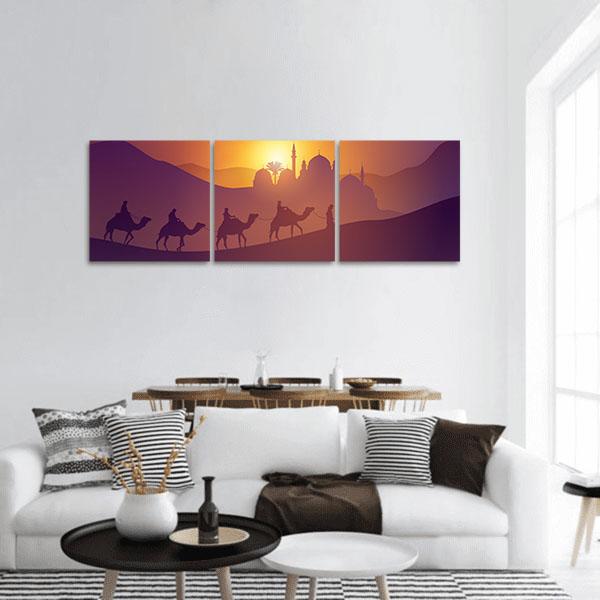 Arabic Desert Caravan at Sunset Panoramic Canvas Wall Art in orange, yellow and purple, hung on a wall