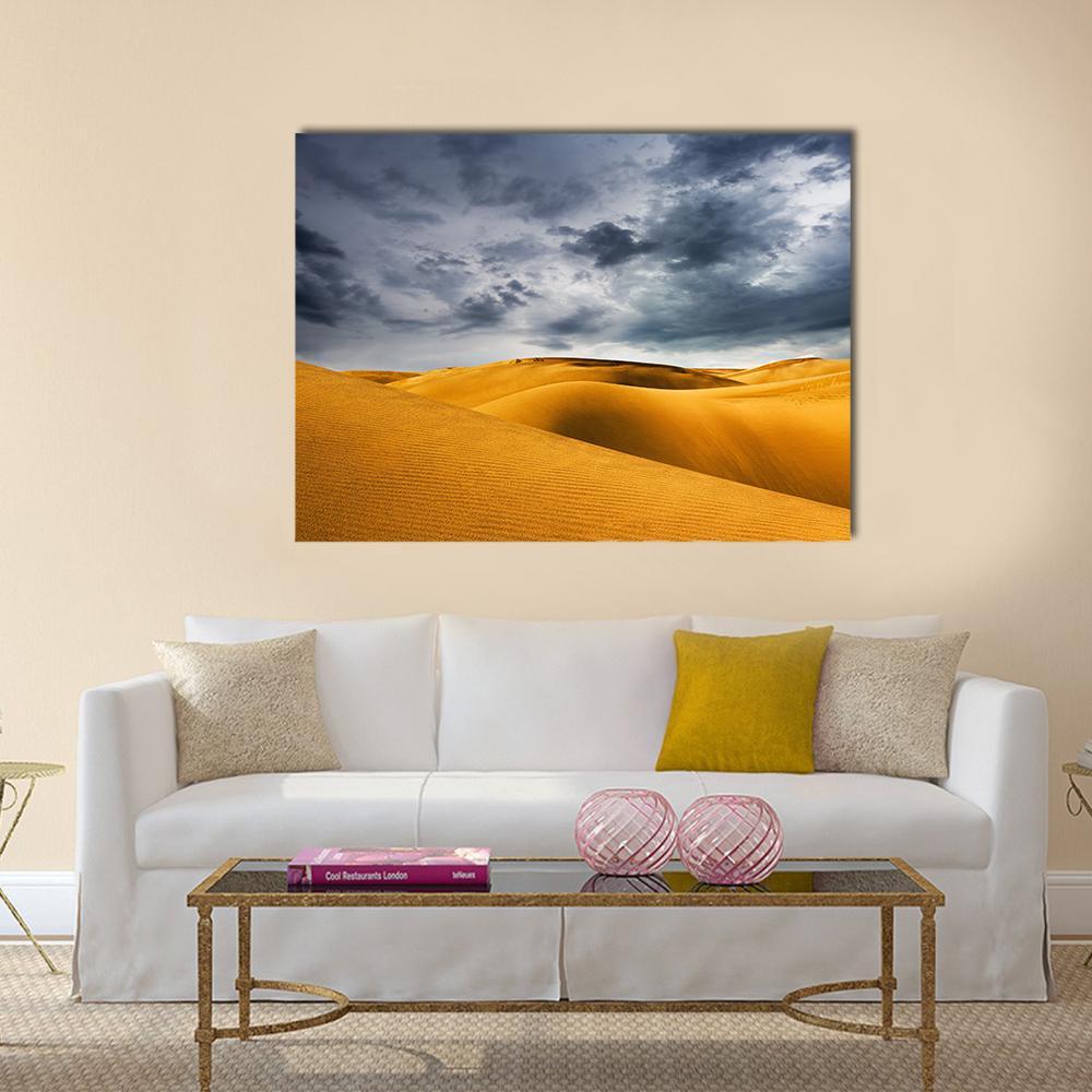 Stormy Sand Dunes Landscape Canvas Wall Art in gray, yellow and blue, single panel hung on a wall