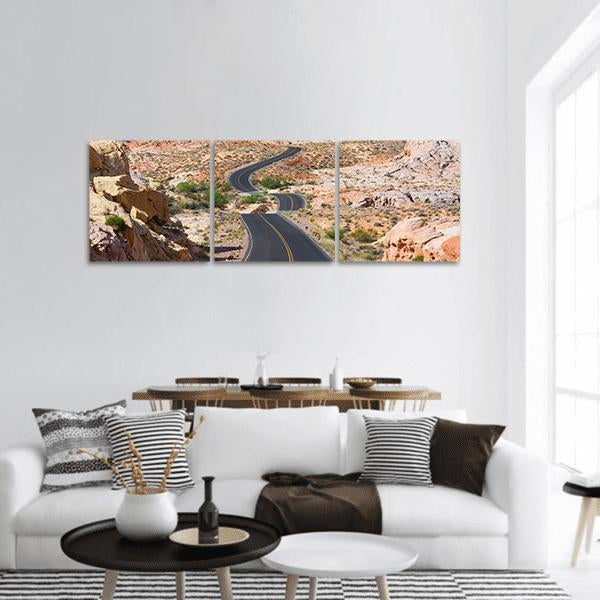 Winding Desert Road with Double Yellow Lines Panoramic Canvas Wall Art in gray, brown and orange, hung on a wall
