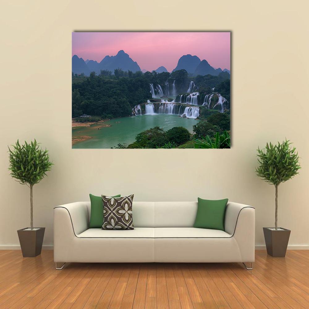 Detian Waterfall at Sunset Canvas Wall Art in green, blue and pink, single panel hung on a wall