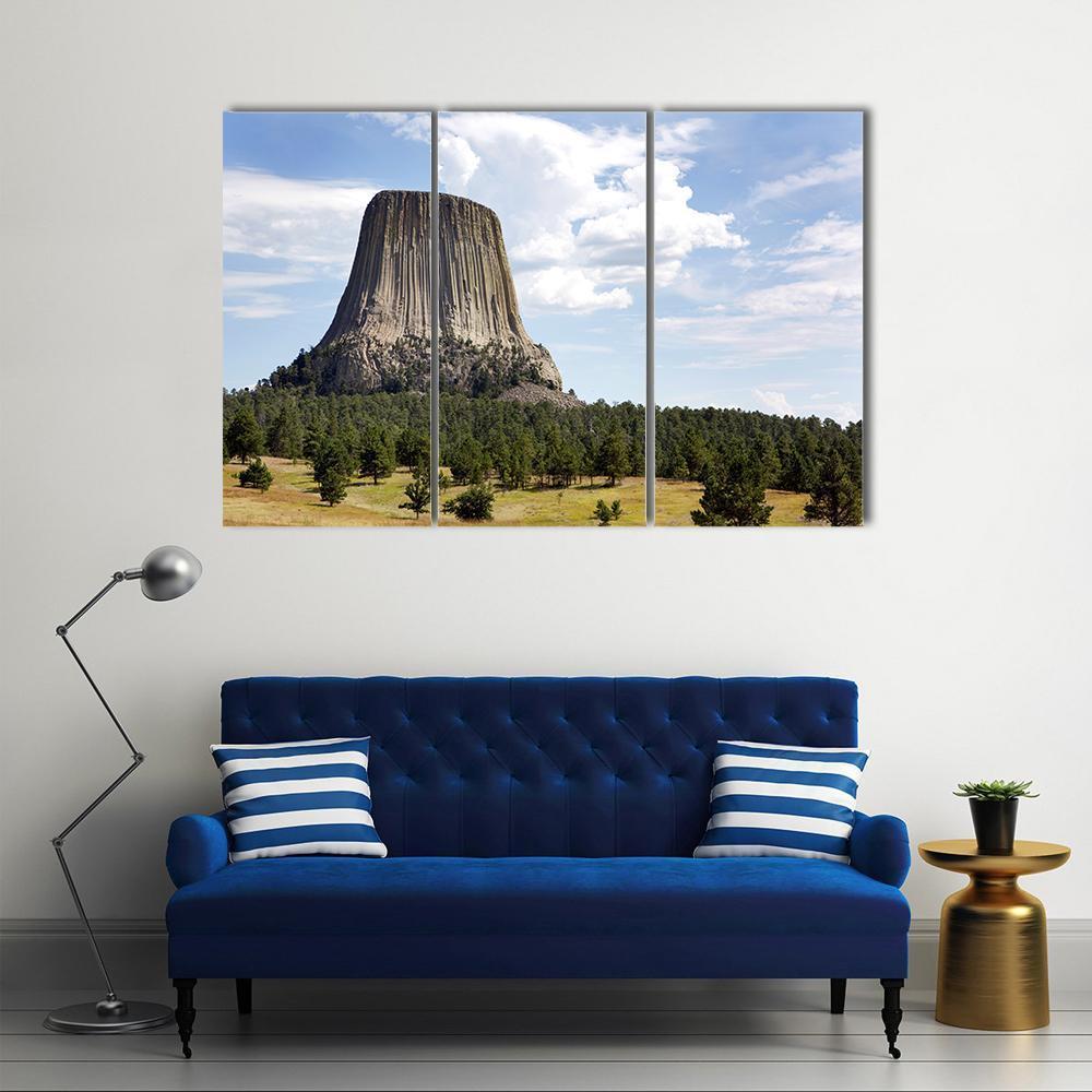 Devils Tower, Wyoming Canvas Wall Art in brown, green and blue, 3 panel horizontal set hung on a wall