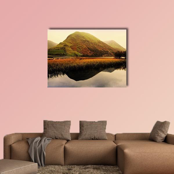 Mountain Reflection on Lake at Golden Hour Canvas Wall Art in brown, gold and green, single panel hung on a wall