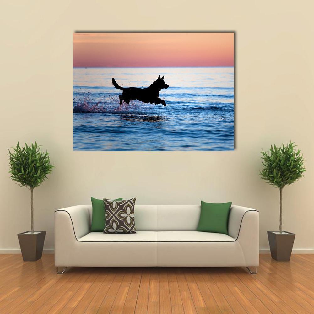 Dog Running on Water Canvas Wall Art in black, orange and blue, single panel hung on a wall