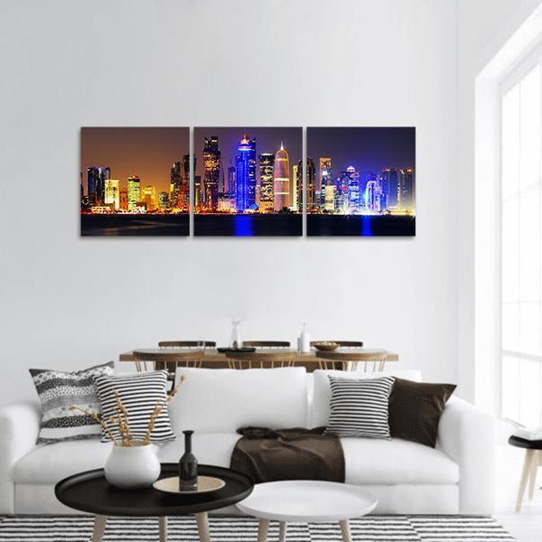 Doha City Skyline at Night Panoramic Canvas Wall Art in black, yellow and blue, hung on a wall