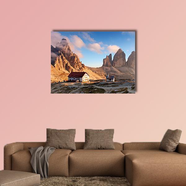 Dolomites Sunset with Alpine Huts Canvas Wall Art in brown, orange and blue, single panel hung on a wall