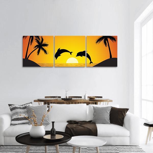 Dolphins Jumping at Sunset Panoramic Canvas Wall Art in black, orange and yellow, hung on a wall