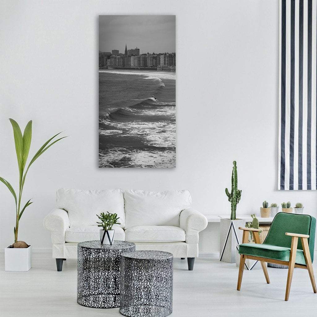 Crescent Beach Cityscape with Surfer Vertical Canvas Wall Art in black, white and gray, hung on a wall
