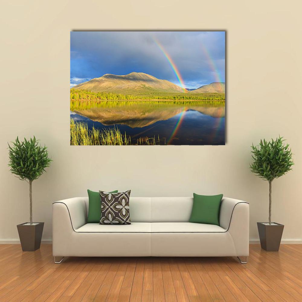 Double Rainbow Over Lake and Mountains Canvas Wall Art in yellow, green and blue, single panel hung on a wall