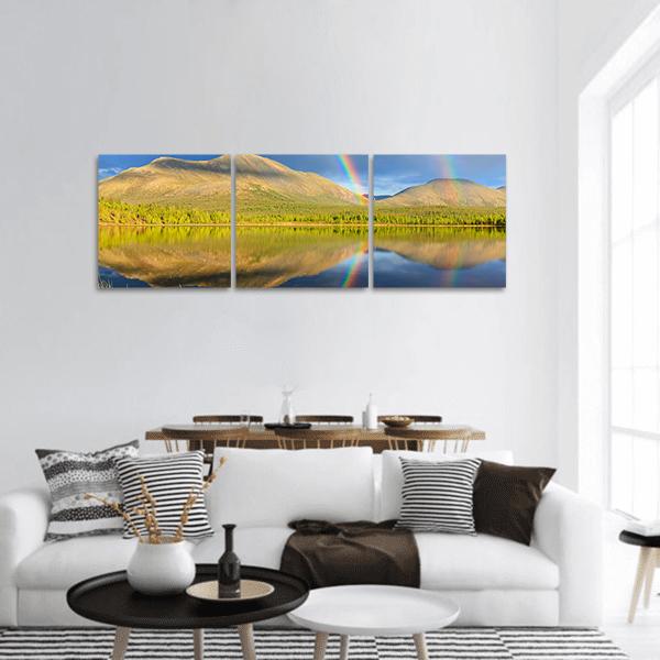 Double Rainbow Over Mountain Lake at Golden Hour Panoramic Canvas Wall Art in yellow, green and blue, hung on a wall
