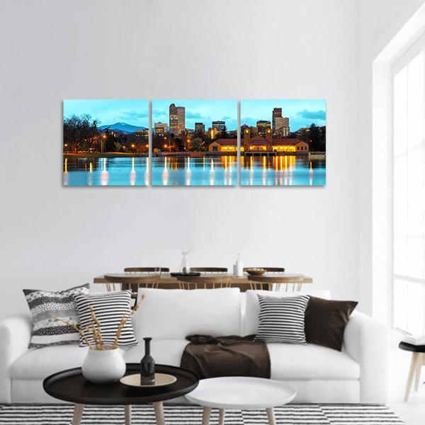 Downtown Denver Boathouse Reflections Panoramic Canvas Wall Art in orange, yellow and blue, hung on a wall