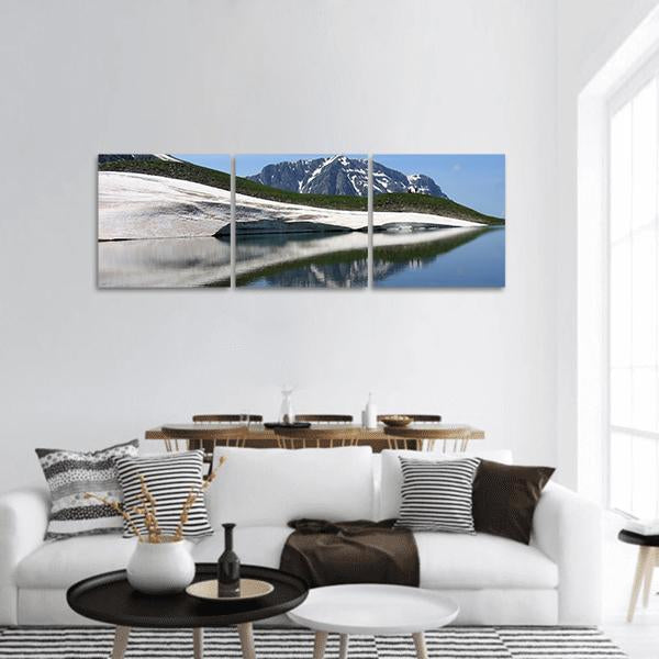 Dragon Lake and Astraka Peak Panoramic Canvas Wall Art in white, green and blue, hung on a wall