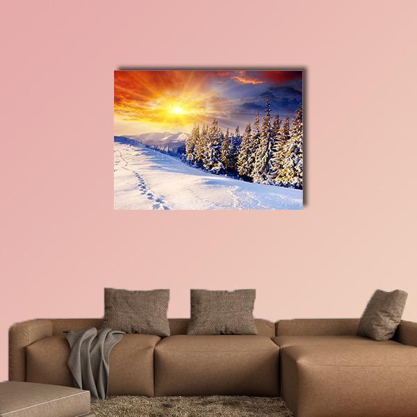 Winter Sunset Over Snowy Mountains Canvas Wall Art in white, orange and yellow, single panel hung on a wall