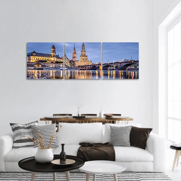 Elbe River Cityscape at Dusk Panoramic Canvas Wall Art in gold, blue and navy, hung on a wall
