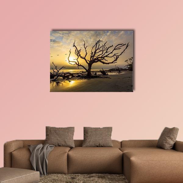 Tangled Driftwood at Sunset Beach Canvas Wall Art in brown, orange and yellow, single panel hung on a wall