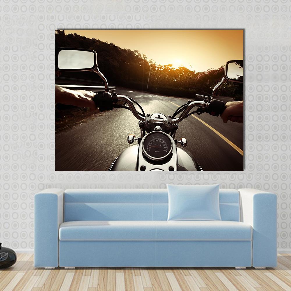 First-person Motorcycle Ride at Sunset Canvas Wall Art in black, orange and yellow, single panel hung on a wall