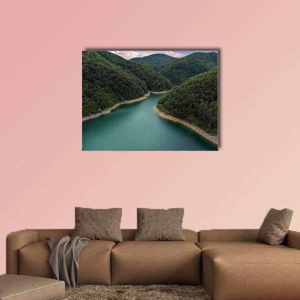 Aerial Lake with Turquoise River Canvas Wall Art in green and blue, single panel hung on a wall