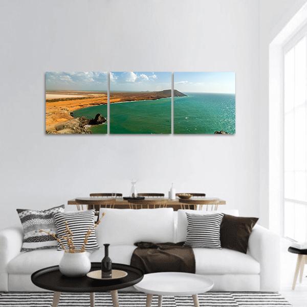La Guajira Coastal Landscape Panoramic Canvas Wall Art in orange, yellow and blue, hung on a wall