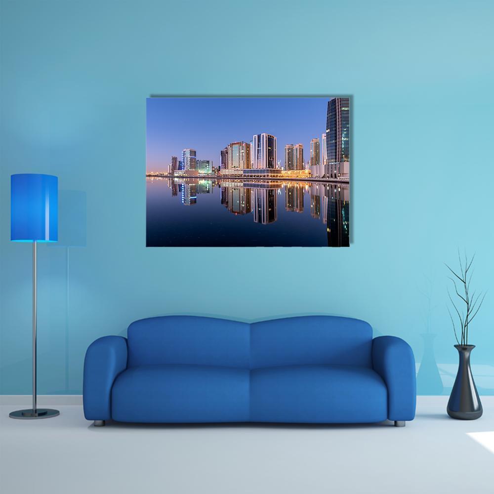 Dubai Canal Reflection Canvas Wall Art in gold, blue and navy, single panel hung on a wall