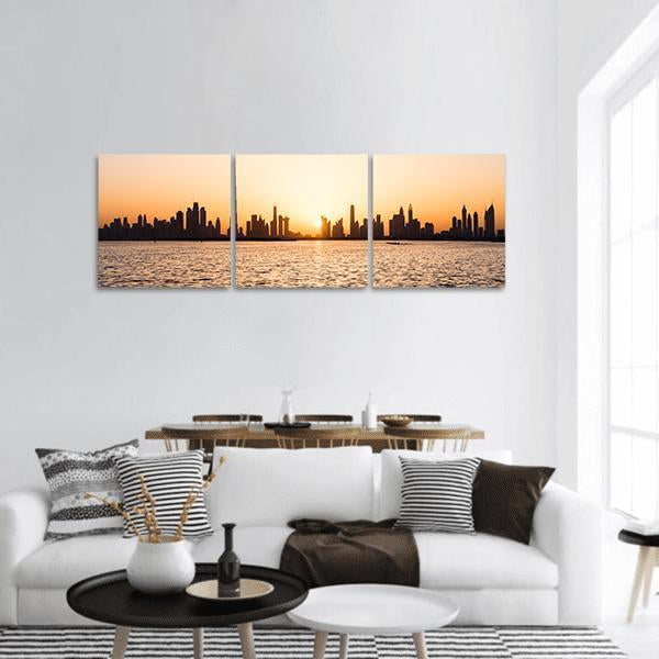 Dubai Skyline at Sunset Panoramic Canvas Wall Art in black, orange and yellow, hung on a wall
