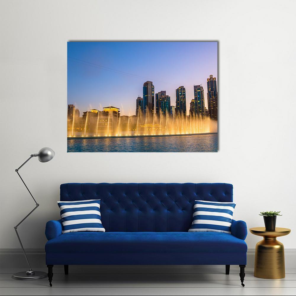 Dubai Fountain at Dusk Canvas Wall Art in gold, yellow and blue, single panel hung on a wall