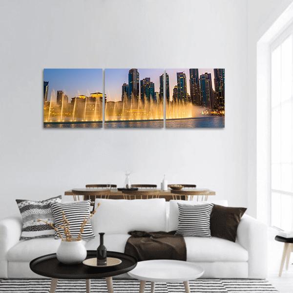 Dubai Fountain Twilight Skyline Panoramic Canvas Wall Art in orange, yellow and blue, hung on a wall