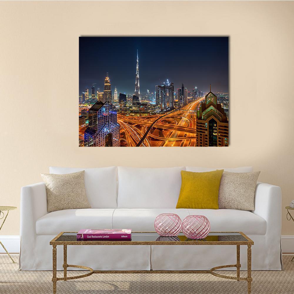 Dubai Night Skyline with Illuminated Roads Canvas Wall Art in black, gold and blue, single panel hung on a wall