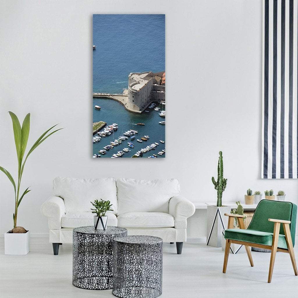 St John's Fortress Over Dubrovnik Harbor Vertical Canvas Wall Art in gray and blue, single vertical panel hung on a wall