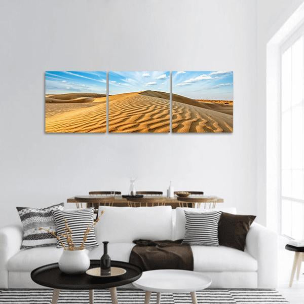 Thar Desert Sand Dunes Panoramic Canvas Wall Art in orange, yellow and blue, hung on a wall
