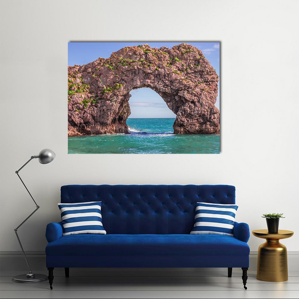 Durdle Door Sea Arch Canvas Wall Art in brown, green and blue, single panel hung on a wall