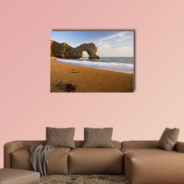 Durdle Door Natural Rock Arch Canvas Wall Art in beige, brown and blue, single panel hung on a wall