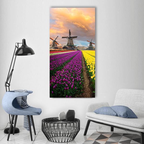 Tulip Fields with Dutch Windmills Vertical Canvas Wall Art in orange, yellow and purple, single vertical panel hung on a wall