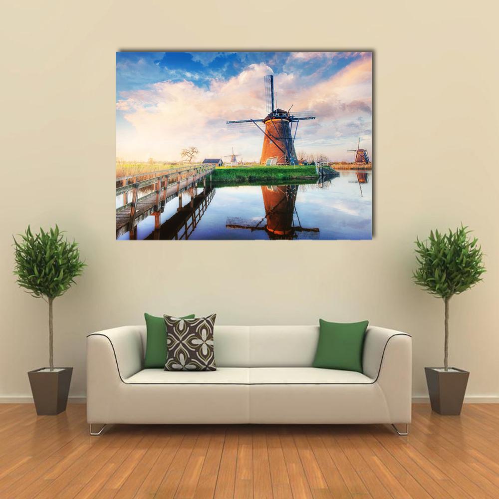 Dutch Windmills at Sunset Canvas Wall Art in brown, orange and blue, single panel hung on a wall
