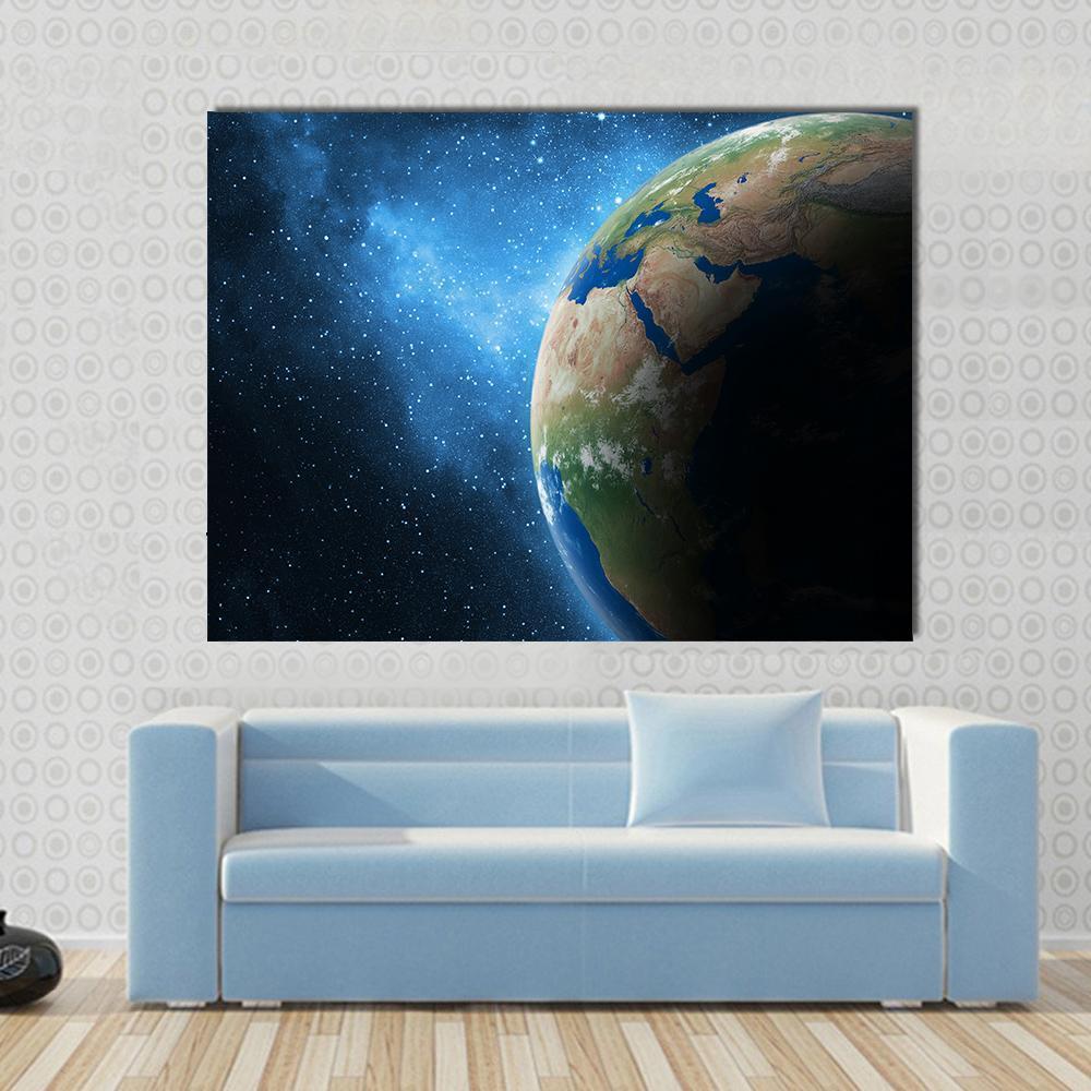 Earth and Galaxy Canvas Wall Art in black and blue, single panel hung on a wall