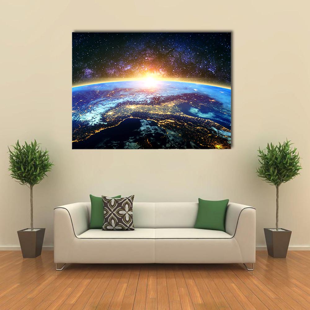 Earth at Dawn with the Milky Way Canvas Wall Art in black, yellow and blue, single panel hung on a wall