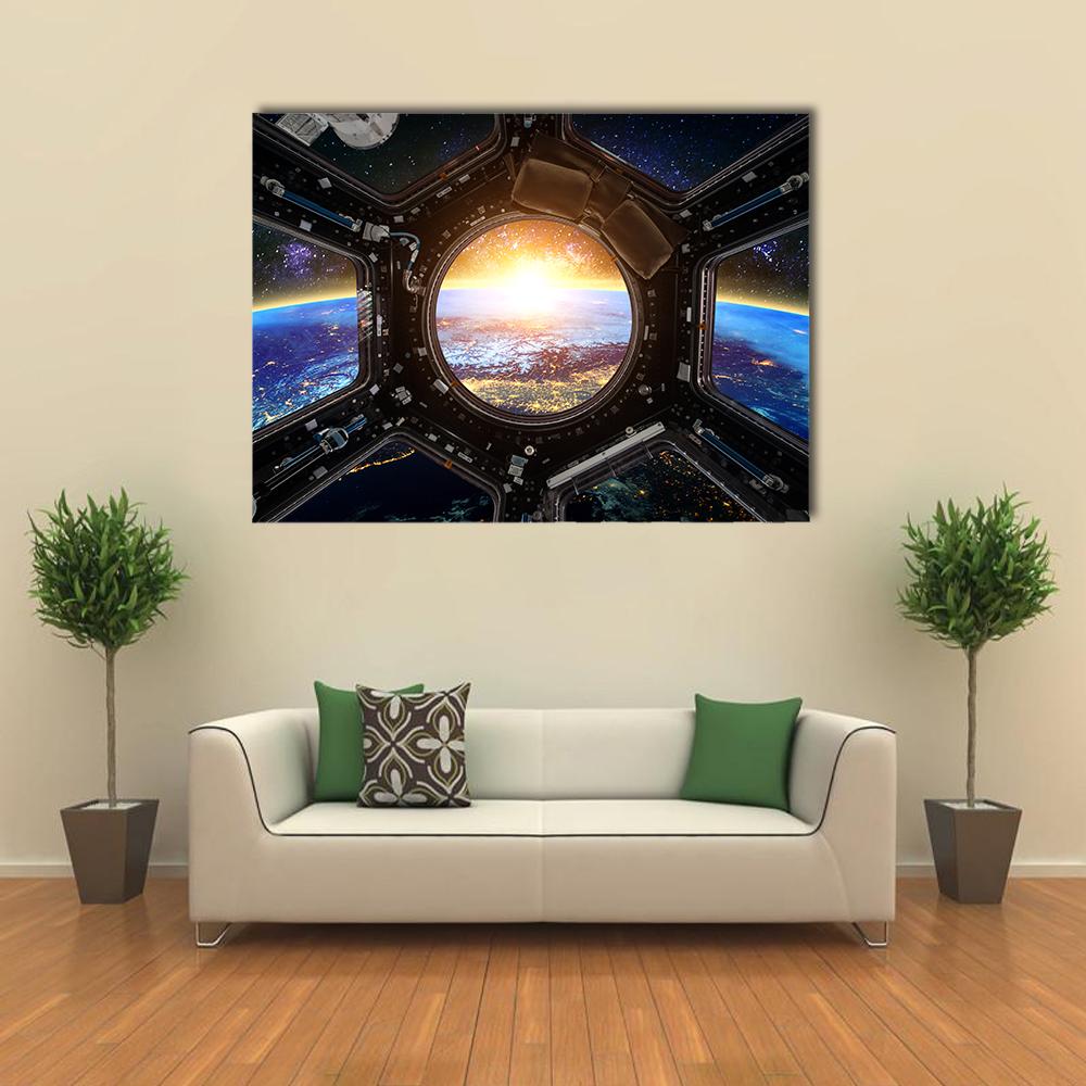 Sunrise Over Earth from Cupola Canvas Wall Art in black, yellow and blue, single panel hung on a wall