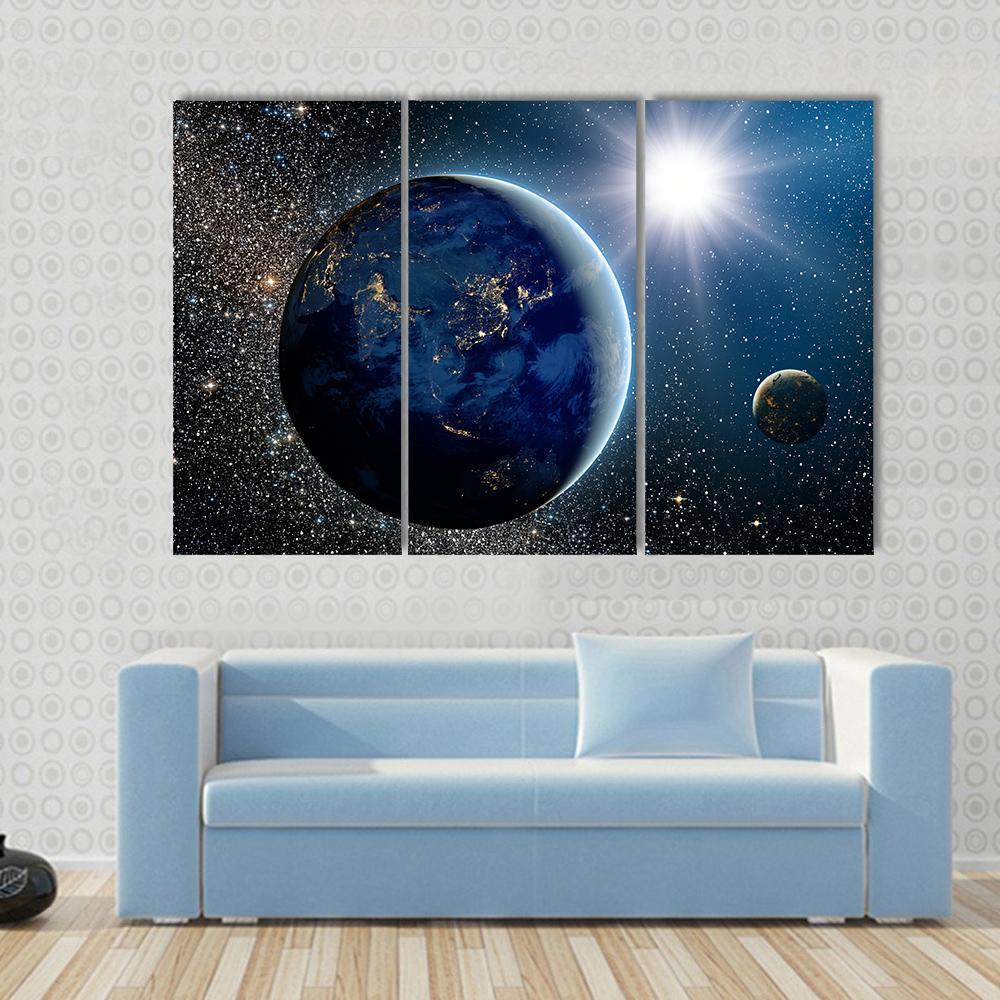 Earth & Sun from Space Canvas Wall Art in black, white and blue, 3 panel horizontal set hung on a wall