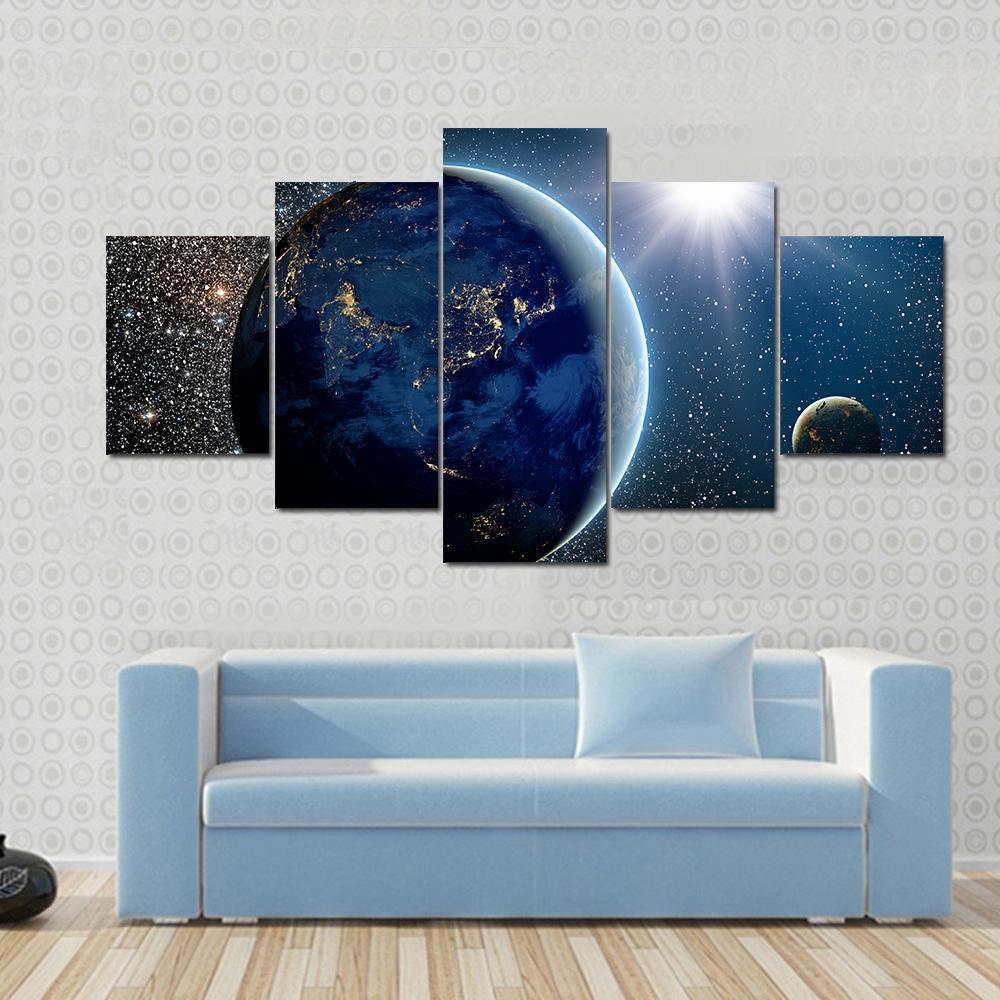 Earth & Sun from Space Canvas Wall Art in black, white and blue, 5 panel Star layout hung on a wall
