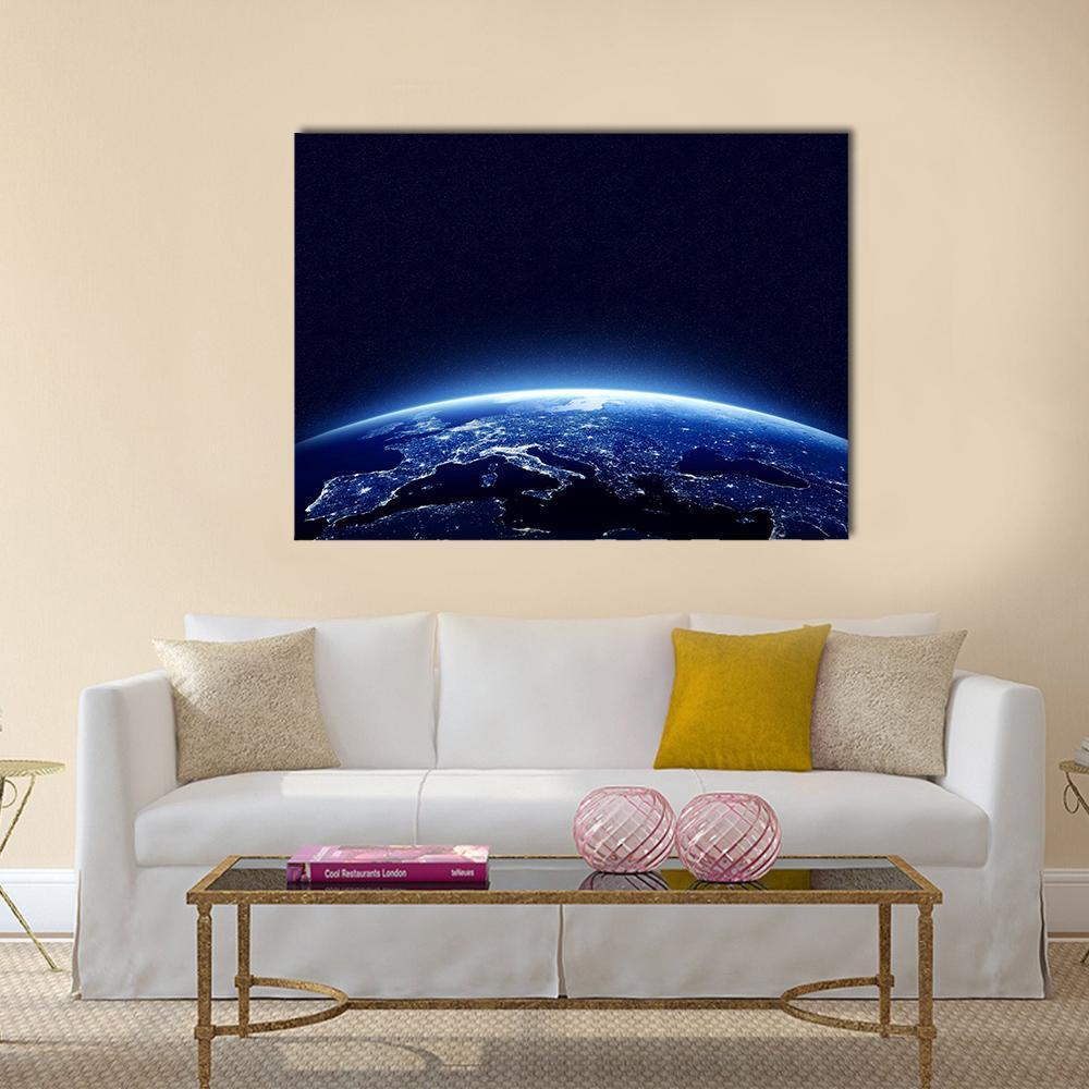 Earth at Night with City Lights Canvas Wall Art in black and blue, single panel hung on a wall