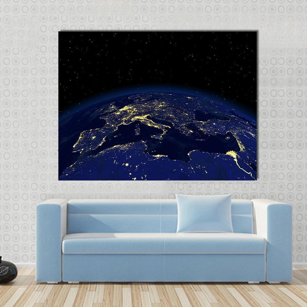 Earth at Night Canvas Wall Art in black, gold and blue, single panel hung on a wall
