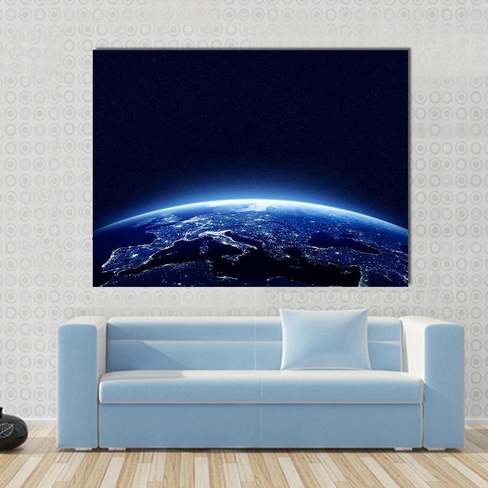 Earth at Night Canvas Wall Art in black and blue, single panel hung on a wall