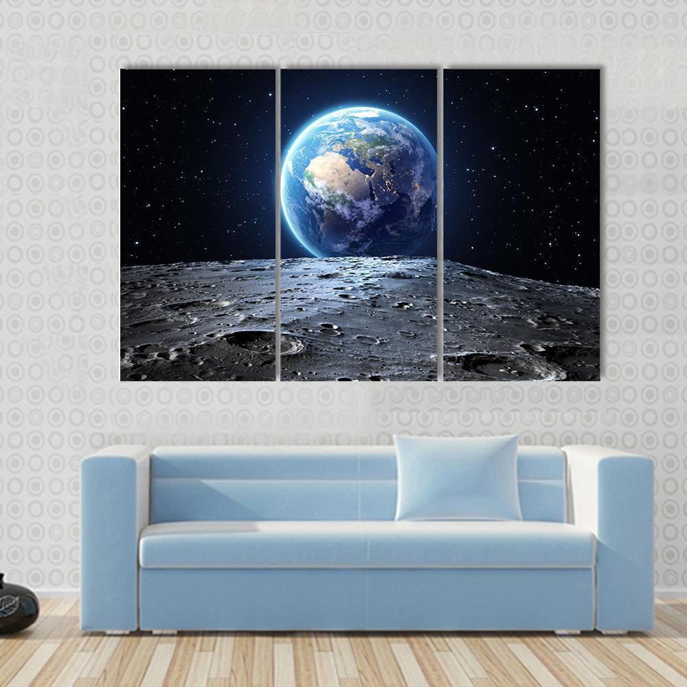 Earth from Moon Surface Canvas Wall Art in black, gray and blue, 3 panel horizontal set hung on a wall