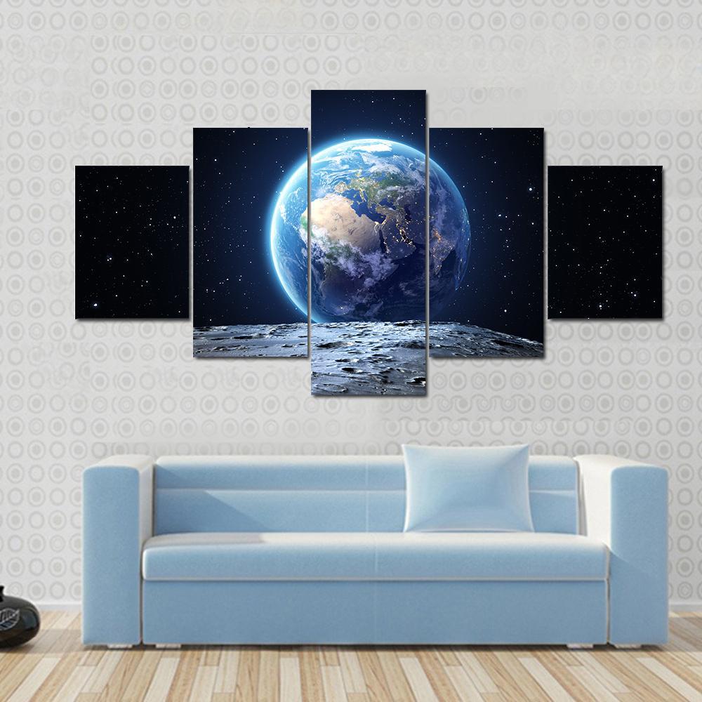 Earth from Moon Surface Canvas Wall Art in black, gray and blue, 5 panel Star layout hung on a wall