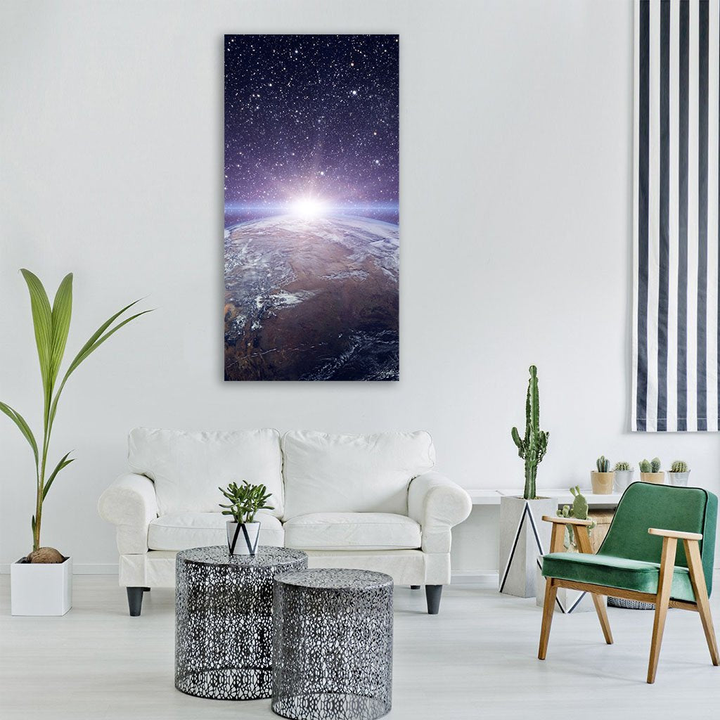 Sunrise Over Earth from Orbit Vertical Canvas Wall Art in black, white and blue, single vertical panel hung on a wall