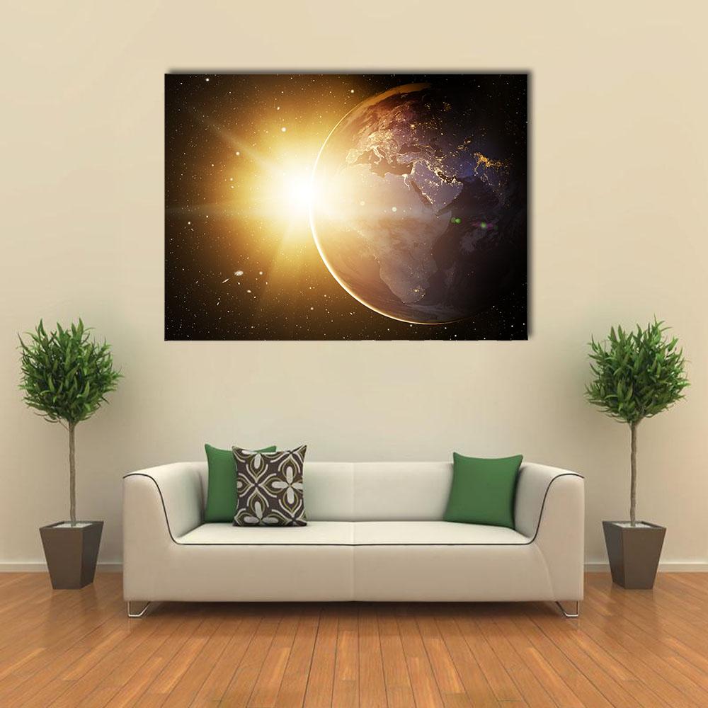 Earth from Orbit at Sunrise Canvas Wall Art in black, gold and yellow, single panel hung on a wall