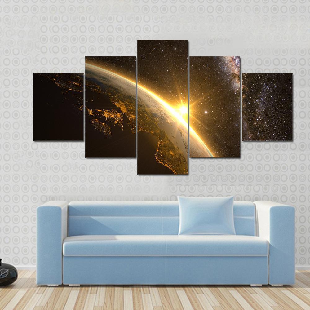 Earth with Spectacular Sunrise Canvas Wall Art in black, orange and yellow, 5 panel Star layout hung on a wall