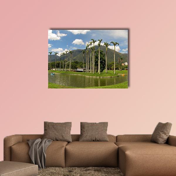 Palm-lined Mountain Lake with Two Boats Canvas Wall Art in brown, green and blue, single panel hung on a wall