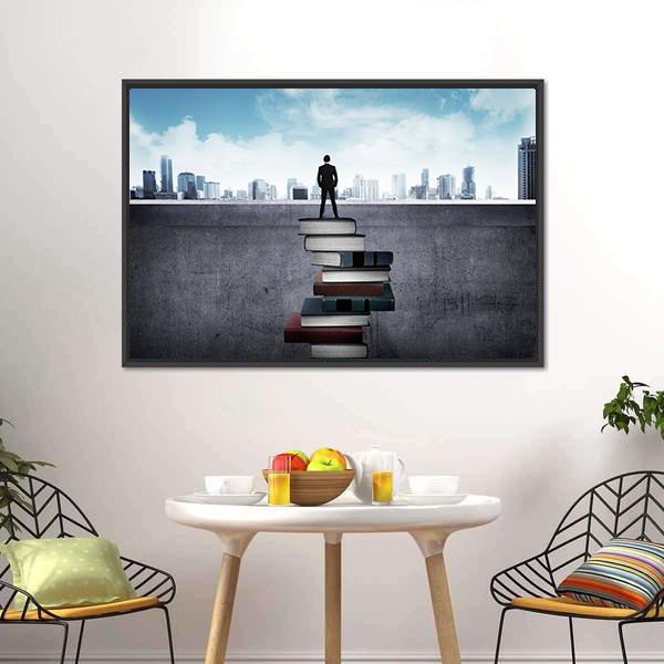 Man Standing on Books Over Cityscape Canvas Wall Art in black, gray and blue, framed canvas, product view on a white background
