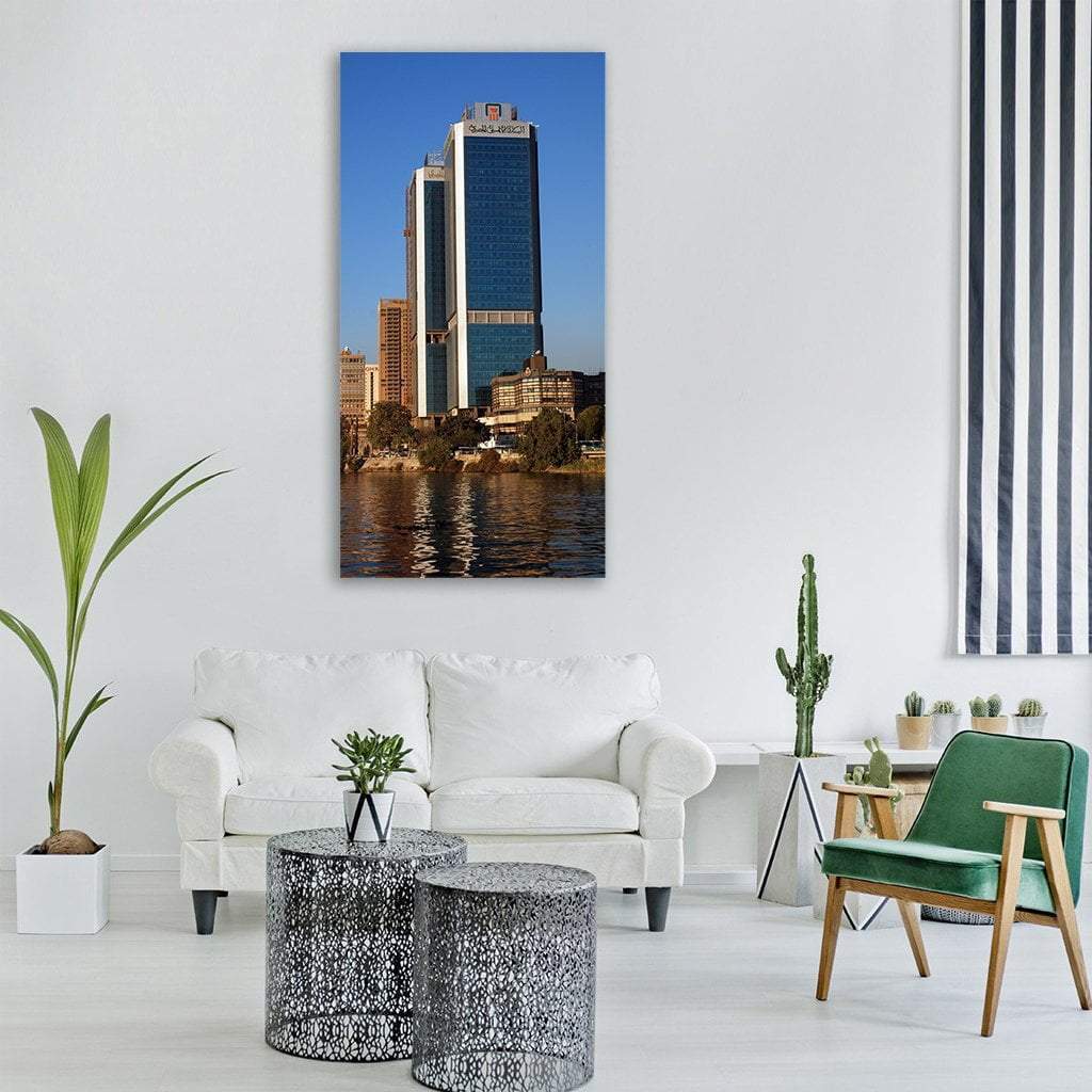 Nile City Towers Reflections Vertical Canvas Wall Art in gray, brown and blue, single vertical panel hung on a wall